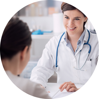 A smiling healthcare professional engages warmly with a patient during a consultation, showcasing a friendly and supportive atmosphere.